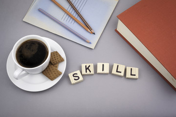 Text: Skill from wooden letters on a gray desk