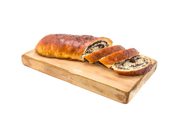 Sliced Poppy roll on the board isolated on white