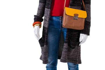 Leather bag with sweater coat. Mannequin wearing coat and accessories. Woman's autumn apparel with handbag. Big discounts at outlet shop.