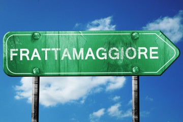 Frattamggiore road sign, vintage green with clouds background
