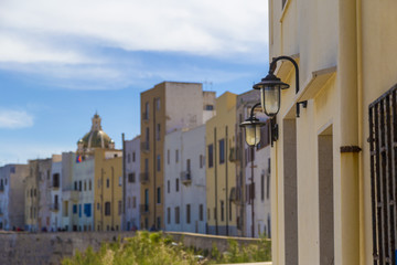 Fototapeta na wymiar Colorful apartment buildings in Trapani Port in Sicily, Italy during clear sunny day