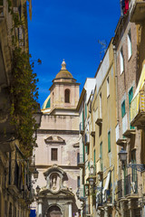 Fototapeta na wymiar View of old street in Trapani, Sicily with cathedral dome in background