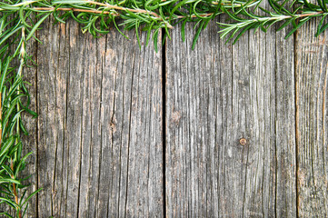 Old wooden background with rosemary frame