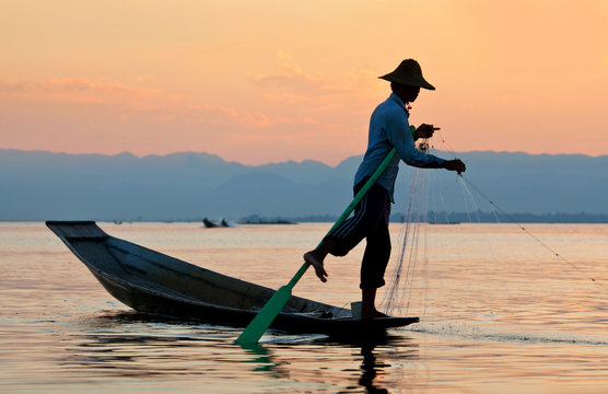 An unidentified Intha fisherman catches fish for food on Inle Lake, Myanmar.