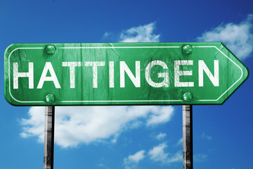 Hattingen road sign, vintage green with clouds background