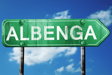 Albenga road sign, vintage green with clouds background