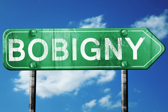 bobigny road sign, vintage green with clouds background