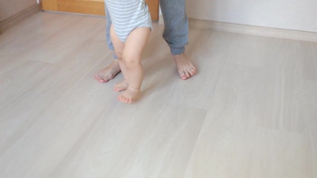 Mother and baby legs. First steps.