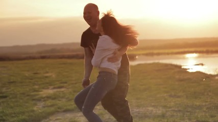 A handsome young  guy turns the girl on the hand