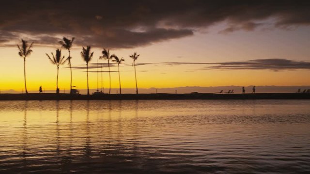 Paradise beach sunset with tropical palm trees. Summer travel holidays vacation getaway colorful concept photo from sea ocean water at Big Island, Hawaii, USA