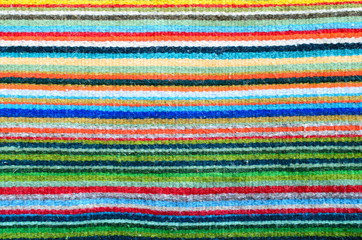 Pattern of colorful stripes - closeup of a woven carpet 