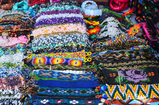 Numerous authentic handmade bid wristbands at the market in Mexico 