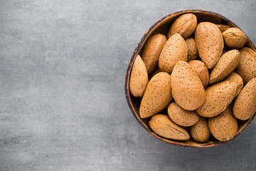 Group of almond nuts with leaves.Wooden background.