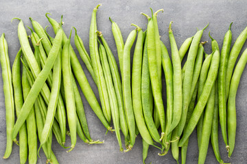 Green beans  on a gray background.