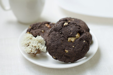 Chocolate cookies with nuts on a souser