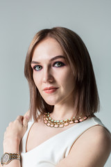 Portrait of young beautiful woman with middle length hair and smoky eyes make-up