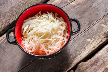 Sauerkraut in a bowl. Bowl of sauerkraut on table. Special ingredient for a salad. Product that has sour taste.