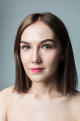 Fototapeta premium Beauty portrait of young model with middle length hair. Professional nude makeup. Green eyes.