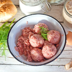 Cooking large homemade meatballs for dinner.