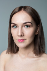Fototapeta premium Beauty portrait of young model with middle length hair. Professional nude makeup. Green eyes.