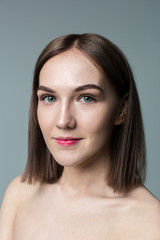 Fototapeta premium Beauty portrait of young model with middle length hair. Professional nude makeup. Green eyes.