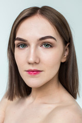 Beauty portrait of young model with middle length hair. Professional nude makeup. Green eyes.