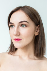 Obraz premium Beauty portrait of young model with middle length hair. Professional nude makeup. Green eyes.