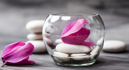 Spa still life with pink orchid, white zen stone and tea candle