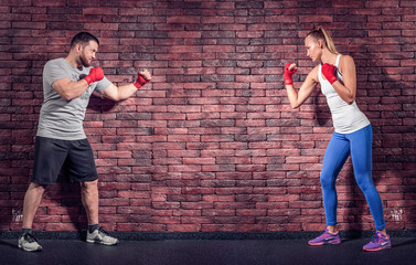Two figters on the Brick wall background are rady for sparring - obrazy, fototapety, plakaty