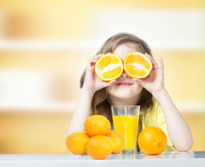 Child with oranges juice glass empty space background.