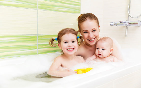 bathing in  bath with foam mother together children baby