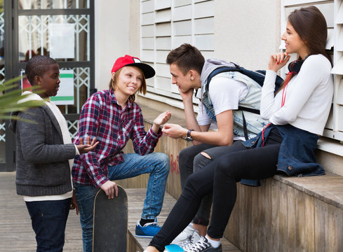 Group of teenage friends relaxing and chatting
