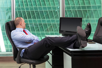 man thoughtfully looking out the window