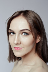 Fototapeta premium Beauty portrait of a pretty girl with makeup matte shadows on the eyes and pink lips
