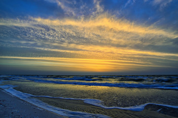 Fototapeta na wymiar Cloudy sky and colorful sunrise on the sea