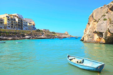 Fototapeta na wymiar Old boat in Harbour of Gozo island in Malta