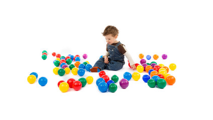Fototapeta na wymiar baby plays with color balls