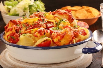 Lumaconi pasta with tomato sauce, bruschetta and salad