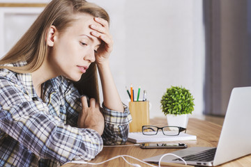 Tired female in office