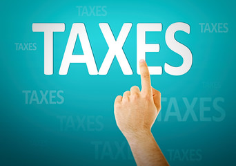 Tax Concept. Male hand push button TAXES