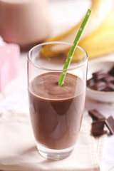Glass of chocolate milk on table close-up