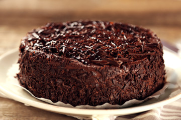 Tasty chocolate cake on wooden background