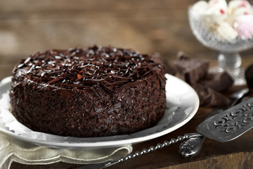 Tasty chocolate cake on wooden background