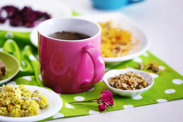 Cup of tea with aromatic dry tea on wooden background