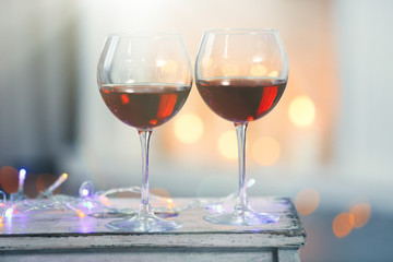 Two glasses of red wine on Christmas decoration background