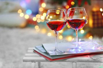 Two glasses of red wine on Christmas decoration background