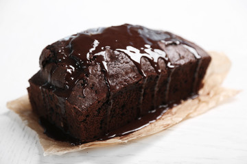 Chocolate cake with icing on white table