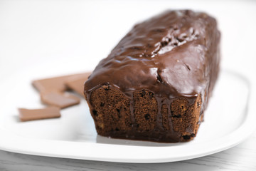 Chocolate cake with icing on white table