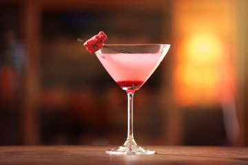 Glass of cocktail on bar background