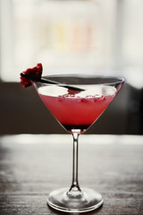 Glass of cocktail on bar background